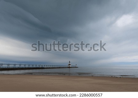 Storm clouds approaching St. Joseph lighthouse and beach.  St. Joseph, Michigan, USA. Royalty-Free Stock Photo #2286000557