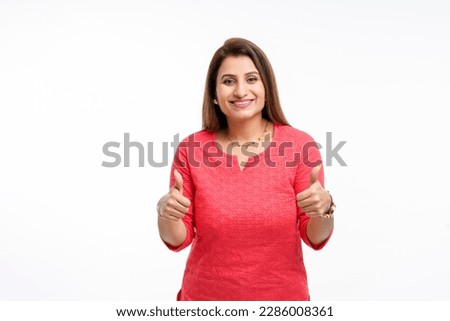 Young indian woman showing thumps up on white background. Royalty-Free Stock Photo #2286008361
