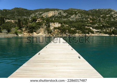 Alipa port, Paleokastritsa, Corfu, Greece, calm water on an empty marina pontoon in Spring. Royalty-Free Stock Photo #2286017487