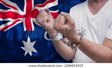 A man getting under arrest in Australia. Concept of being handcuffed, detained, incarcerated and jailed in said country. National law enforcement concept. Royalty-Free Stock Photo #2286019427