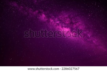 Violet,Pink, Purple night sky milky way and star on dark background.Universe filled with stars, nebula and galaxy with noise and grain.Photo by long exposure and select white balance.