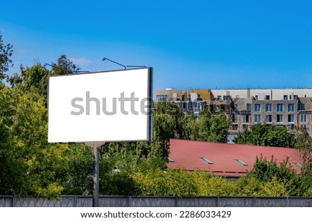 Billboard on the background of a house under construction. Billboard in the city. External advertising. Construction company. Property For Sale. Template for text. Building bussiness.
