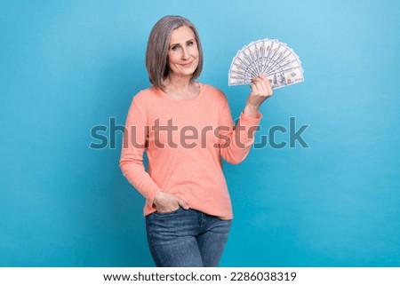 Photo of confident successful rich business lady wear stylish garment hold much money usd banknotes investor isolated on blue color background
