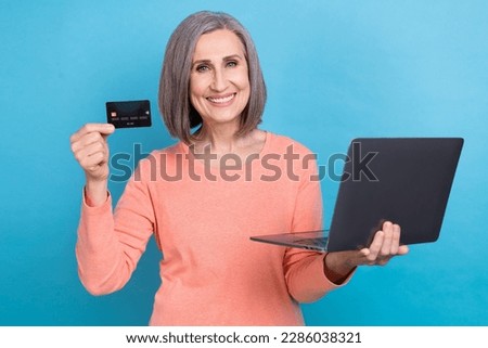 Photo of confident cheerful woman wear coral shirt online shopping modern gadget isolated blue color background