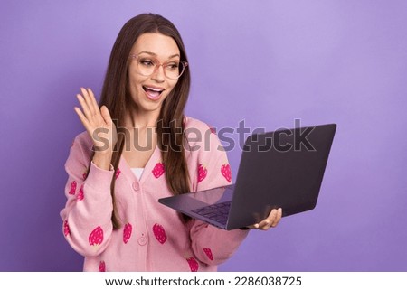 Photo of impressed funky girl wear berry print cardigan eyeglasses communicating modern device isolated violet color background