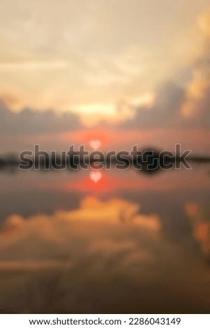 Matahari terbenam di atas air dengan cahaya love blur dari sinar matahari di Laut,blurred background with bokeh images.