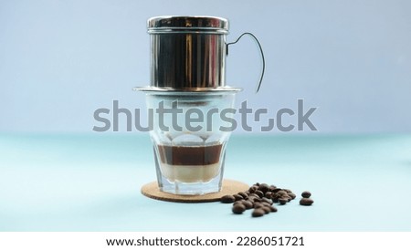 Vietnam drip and coffe beans in the blue background Royalty-Free Stock Photo #2286051721