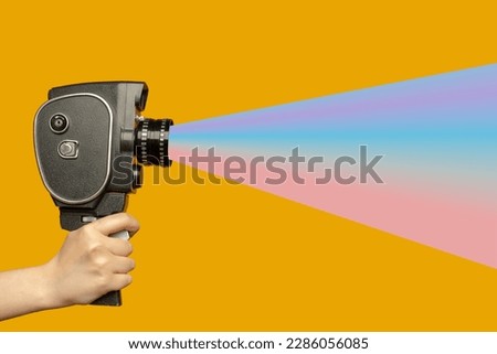 Contemporary art collage. Human hand holding movie camera and spreading fake news. Royalty-Free Stock Photo #2286056085