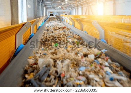 Transportation of fuel obtained from waste (RDF) on a belt to the boiler for combustion. Fuel conveyor. Processing of municipal solid waste into an energy source.   Royalty-Free Stock Photo #2286060035