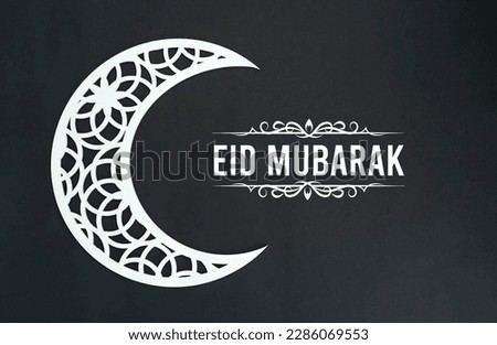 Eid Mubarak background 2023, White crescent moon isolated on black background with Eid greetings Royalty-Free Stock Photo #2286069553