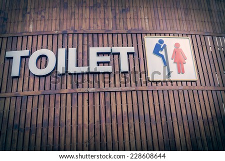 Man and a lady toilet sign on wood background
