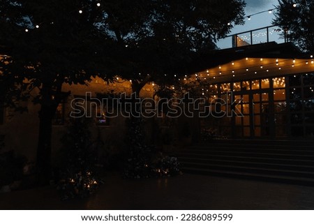 Wedding decorations in Tuscany Italy on evening. Lights and wedding arch in the back yard of the old villa. Royalty-Free Stock Photo #2286089599