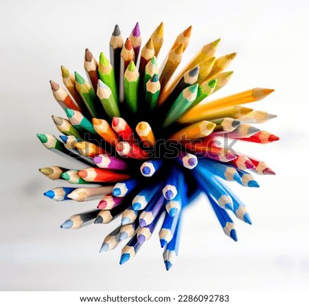 Sharp colorful pencils on watercolor paper, view from above. Multicolor crayons pallete for artist inspiration Royalty-Free Stock Photo #2286092783