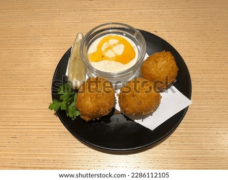 Potato croquettes - mashed potatoes balls breaded and deep fried, served with mayonnaise and lemon. Crispy balls. Three chicken crispy balls. Homemade Fried Risotto Arancini