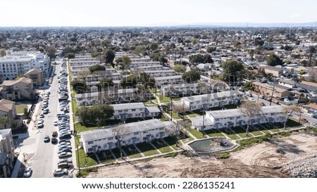 Afternoon aerial neighborhood view of historic public housing projects in Watts, California, USA. Royalty-Free Stock Photo #2286135241