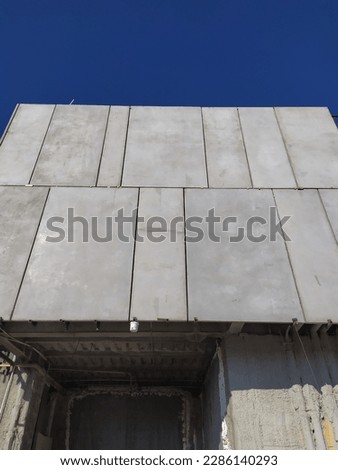 Implementation of exposed modular concrete facade wall, large concrete panels are being installed