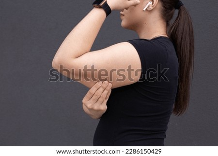Bingo wings, female arm with loose skin. Royalty-Free Stock Photo #2286150429