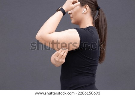 Bingo wings, female arm with loose skin. Royalty-Free Stock Photo #2286150693