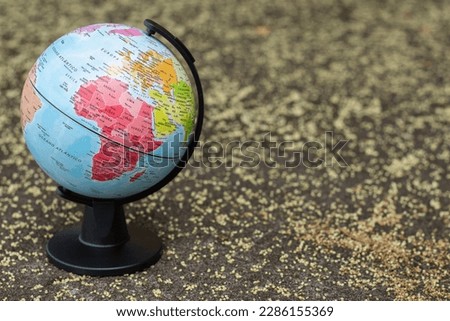 earth globe on a beige textured background showing continent Africa and the Middle East