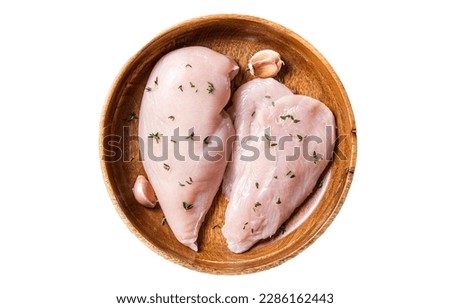 Sliced raw Chicken breast fillet, poultry meat steaks in plate. B Isolated on white background. Royalty-Free Stock Photo #2286162443