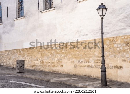 A street lamp on a cobblestone street in Montmartre, in Paris, France. Royalty-Free Stock Photo #2286212161