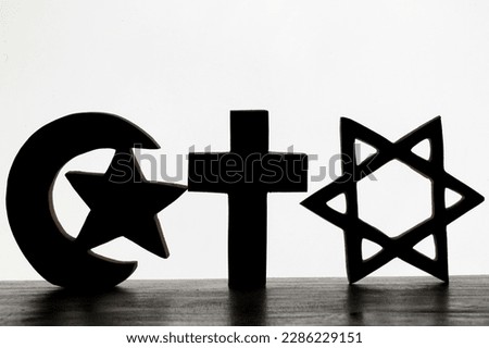 A jewish star of david, an islamic star and crescent symbol and a christian cross. Interfaith concept.  Religious symbols of Catholicism, Islam and Judaism. Interreligious and spirituality concept. Royalty-Free Stock Photo #2286229151