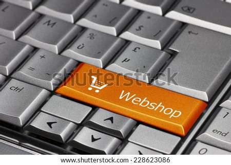 Computer key orange - Webshop with cart symbol