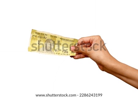 Hand holding Indian 20 rupee note, Selective focus Royalty-Free Stock Photo #2286243199