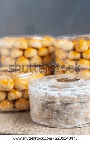 several types of typical Indonesian Eid cakes in clear jars