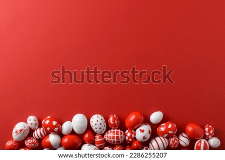 Easter backgrounds, scattered Easter red and white eggs on a bright red background Royalty-Free Stock Photo #2286255207