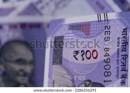 100 rupee closeup shot with rupee background