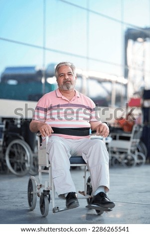 Indian old man sitting on wheel chair and moaning pain. Royalty-Free Stock Photo #2286265541