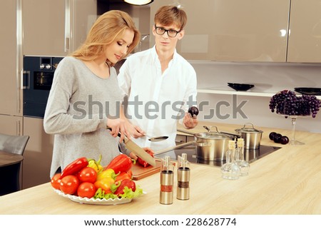 Happy young couple cooking a dinner on a kitchen. Healthy food. Happy family.