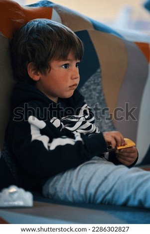 child on the sofa with a blank stare