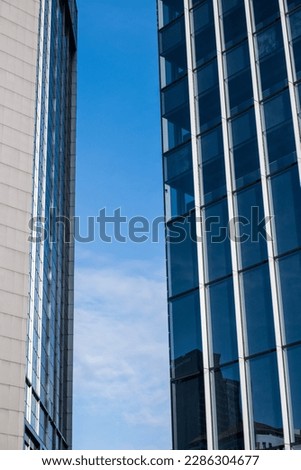 Office building in blue tones against blue sky background