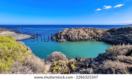 Scenic view on beach Playa El Barranco near Amarilla, Golf del Sur, Tenerife, Canary Islands, Spain, Europe, EU. Cliff and rock formation creating a beautiful turquoise lagoon meandering like river Royalty-Free Stock Photo #2286325347