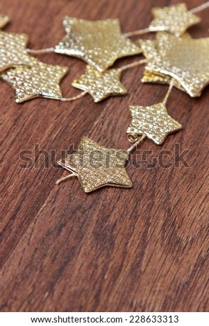 Christmas decoration golden stars over rustic Elm wood background - retro style design, copy space/chritmas decoration golden stars over wooden background o Holiday theme