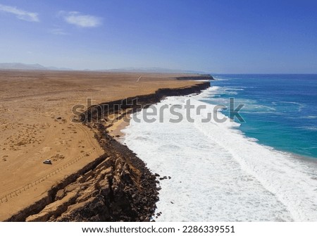 Aerial mid level panoramic view of the rocky cliffs and beaches near El Cotillo in Fuerteventura Spain