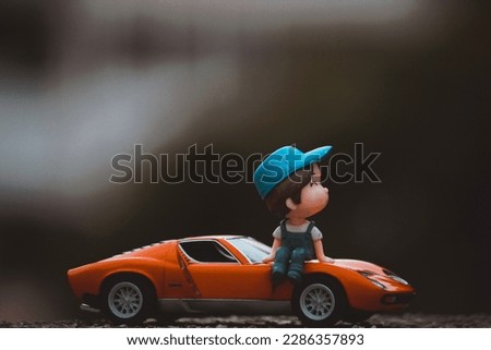 Orange car, blue hat man, waiting for he love one