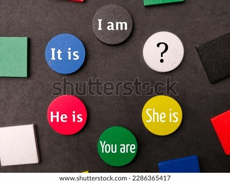 Colored wooden with word I am,It is,He is,You are and She is on black background.