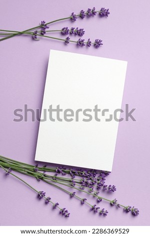 Paper greeting card mockup with lavender flowers, top view, copy space