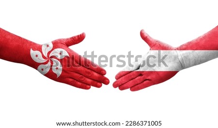 Handshake between Austria and Hong Kong flags painted on hands, isolated transparent image.