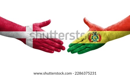 Handshake between Bolivia and Denmark flags painted on hands, isolated transparent image.