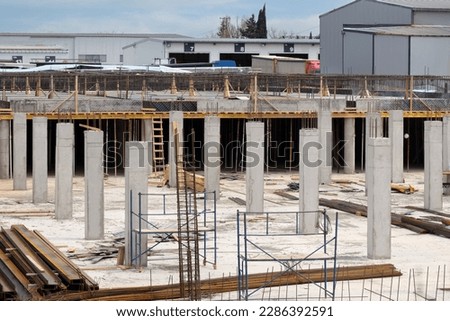Preparation of concrete foundation and construction piles at level 0. Construction of a new trading mall. Royalty-Free Stock Photo #2286392591