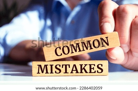 Wooden blocks with words 'Common Mistakes'. Royalty-Free Stock Photo #2286402059