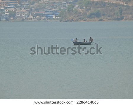 A view of people walking on boats in Pokhara Phewa Lake. Nepali nature photography