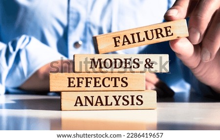 Close up on businessman holding a wooden block with "Failure Modes and Effects Analysis" message Royalty-Free Stock Photo #2286419657