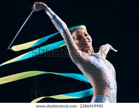 Ribbon gymnastics, woman and portrait on black background of dancer, performance and competition. Female athlete, rhythmic movement and smile for action, creative talent and elegant sports concert