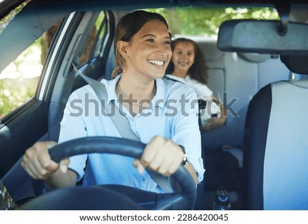 Travel, mother and child in car for drive, fun and sports, soccer and adventure, happy and excited. Mom, driver and girl passenger in vehicle, smile and bonding on road trip to football activity Royalty-Free Stock Photo #2286420045