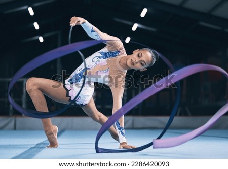 Ribbon, gymnastics and woman dancer in performance, action and sports competition. Female, rhythmic movement and flexible dancing athlete, creative skill and talent of concert event in practice arena Royalty-Free Stock Photo #2286420093